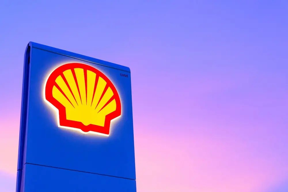 An Image showing the shell logo of a gas station in front of a purple sky