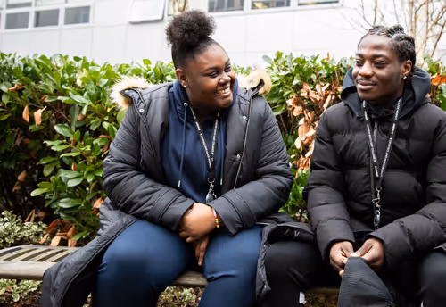 Two college students chatting and smiling