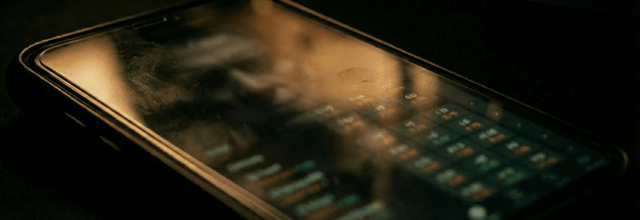 Reflection on a phone screen with sports betting data