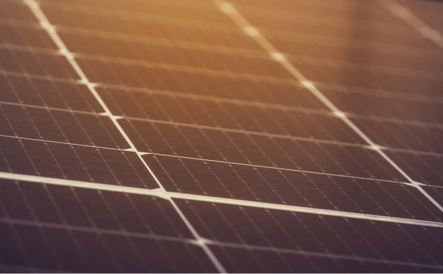 Close-up of solar panels with sunlight reflecting on the surface.