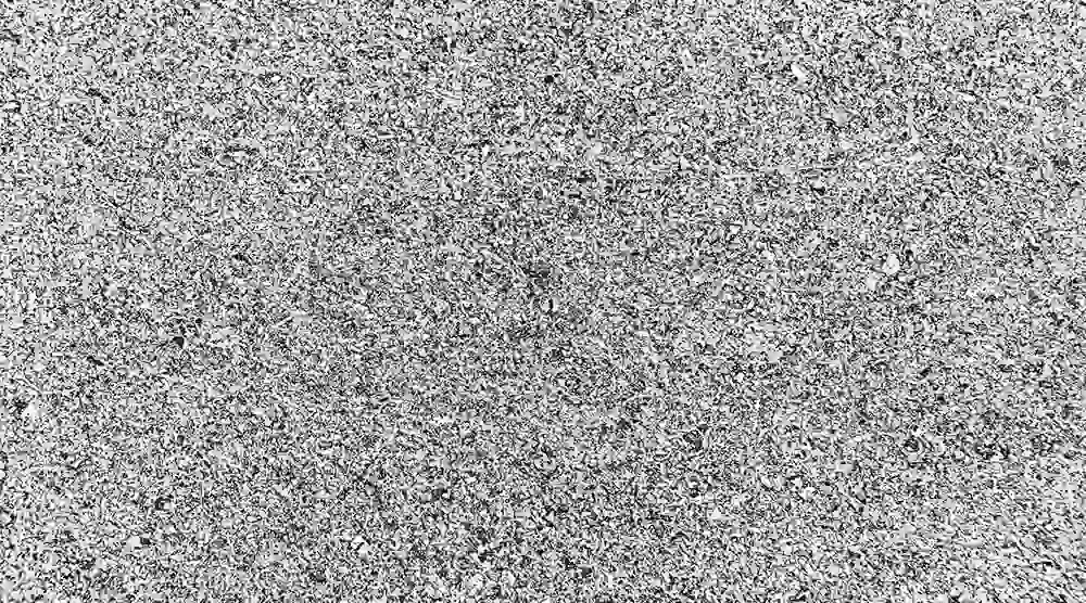 Black and white noise static texture resembling TV or radio signal interference.