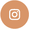 White Instagram logo centered on a round peach-colored background.