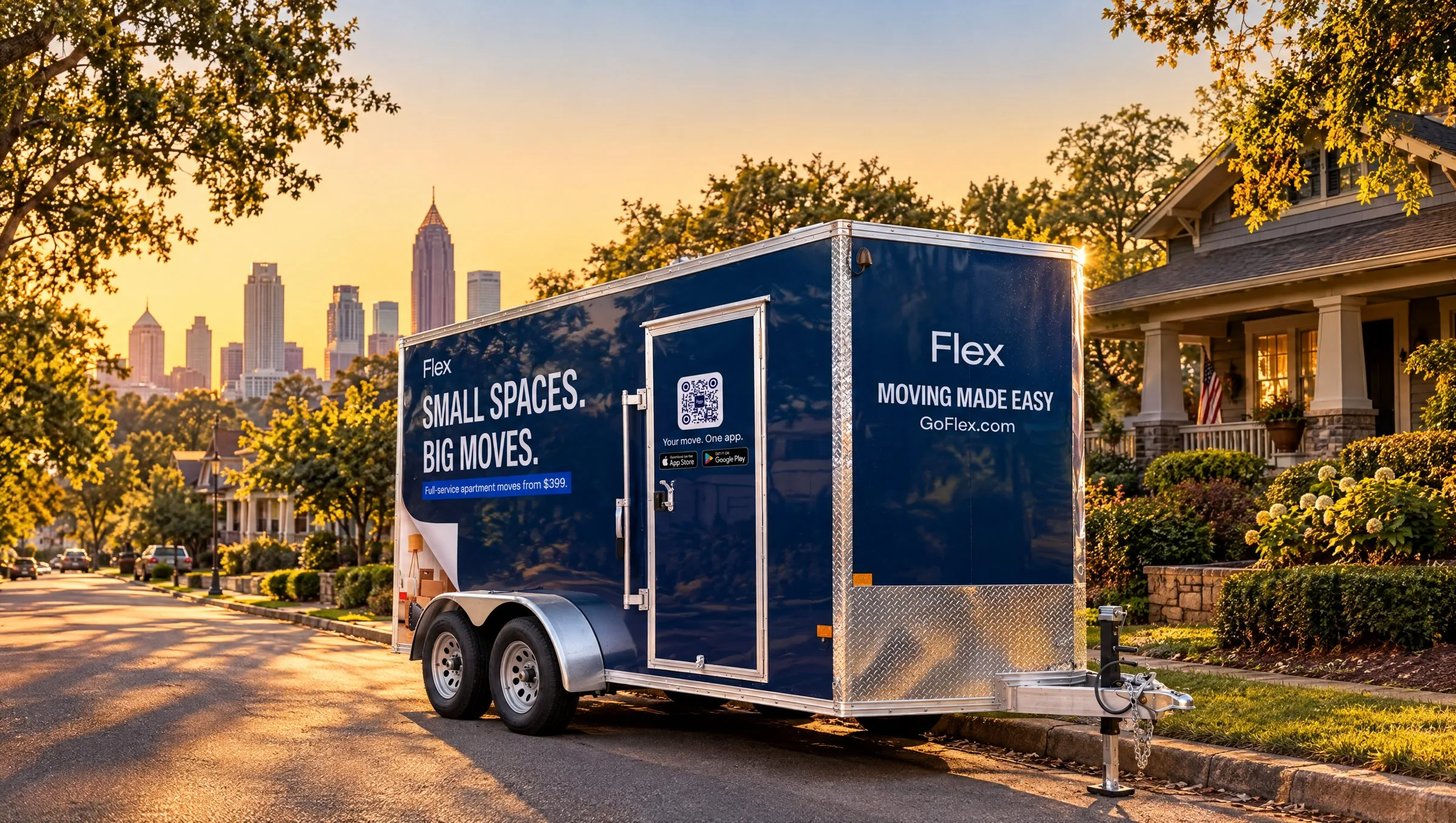 A navy Flex moving trailer parked on a city street at sunset