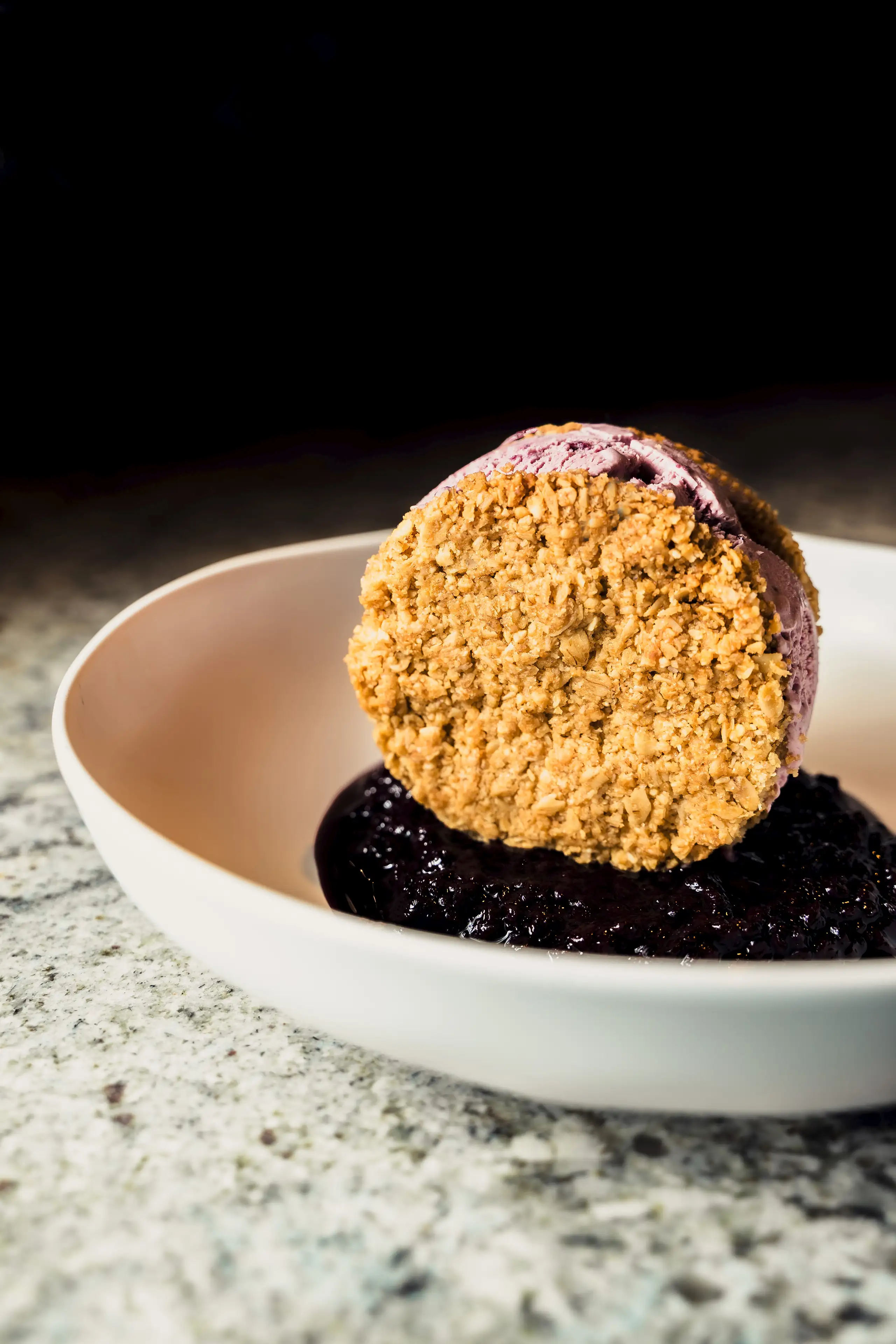 A bowl of food with a cookie on top.