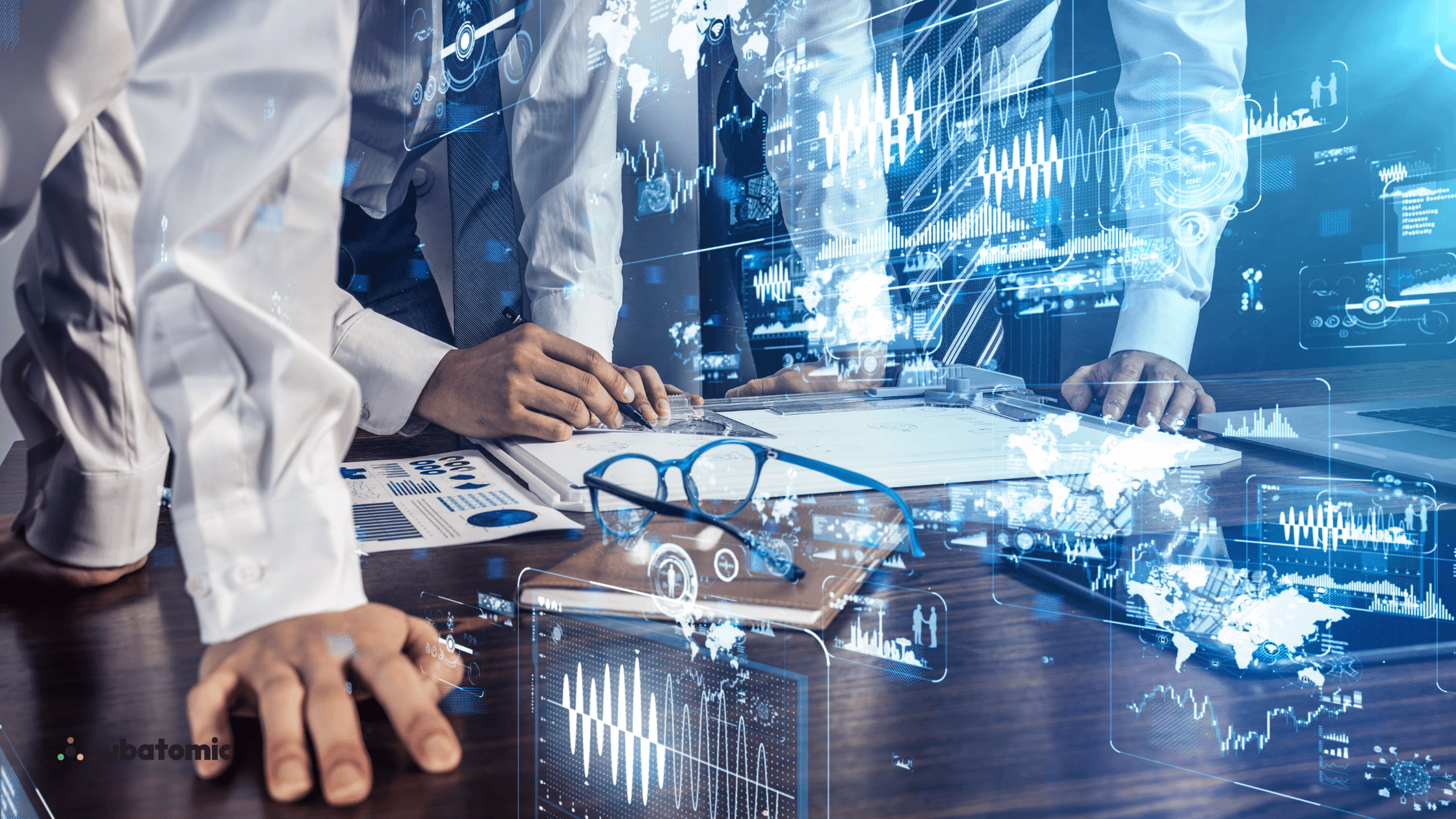 Two business professionals in white shirts reviewing documents at a desk with holographic data charts and global network visualizations overlaid, branded with Subatomic logo