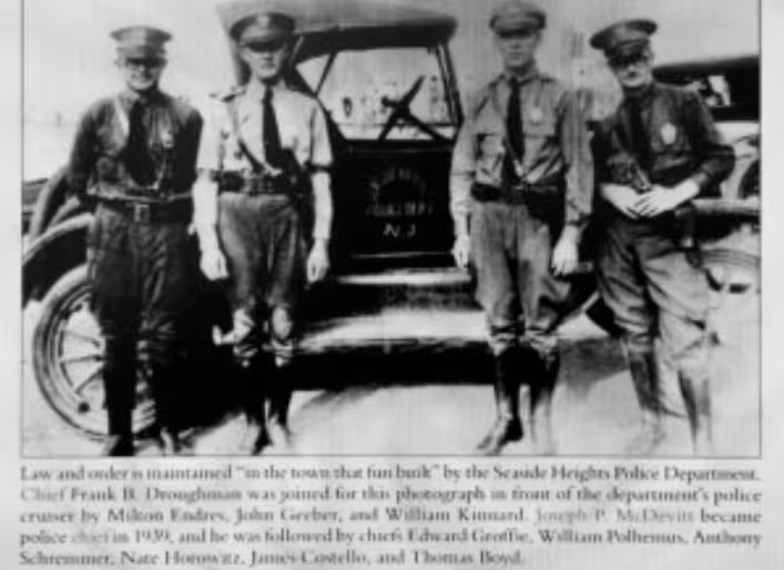Black and white photo of four Seaside Heights police officers standing in front of a vintage police cruiser from the early 20th century.