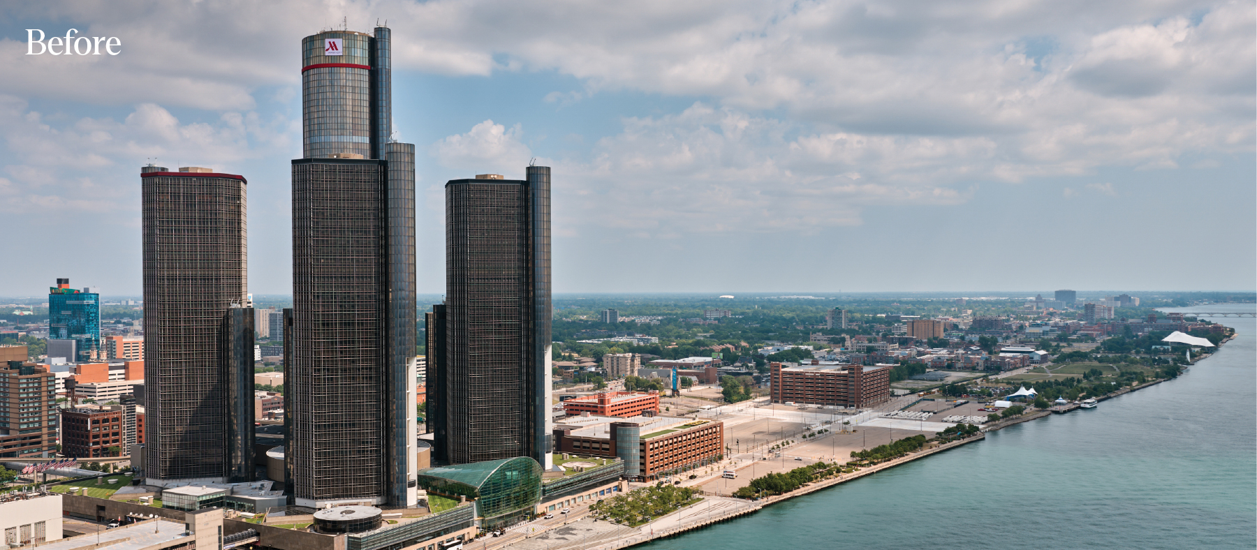 Aerial photo of the current Detroit east riverfront space before redevelopment, featuring the Renaissance Center in the foreground, and text "Before" in the top corner.