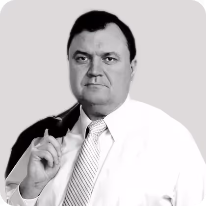 Portrait of a man in a shirt and tie against a neutral background