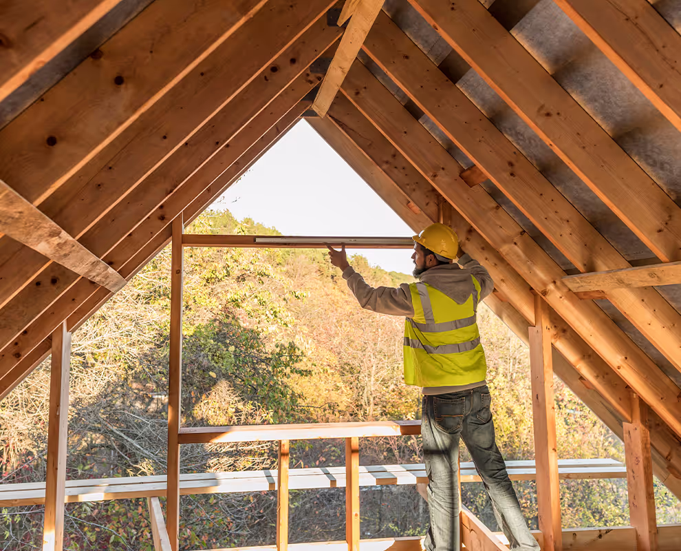 Man putting frames up in a roof