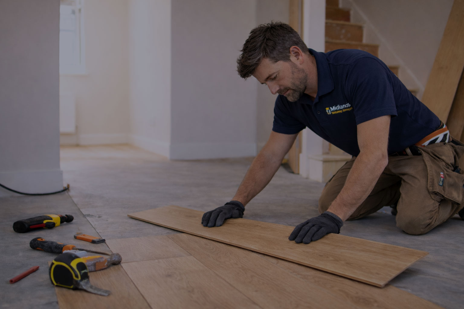 Man laying floorboards