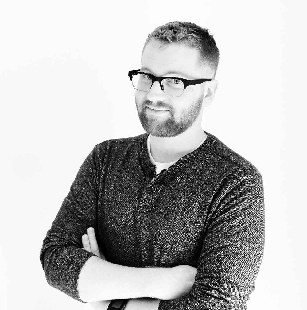 A portrait of Conor Flood in black and white.