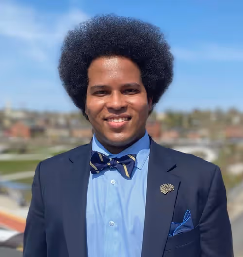 Jared Boyce wearing a blue and gold bowtie and navy blue suit