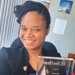 Syreeta Nolan holding a UC San Diego plaque