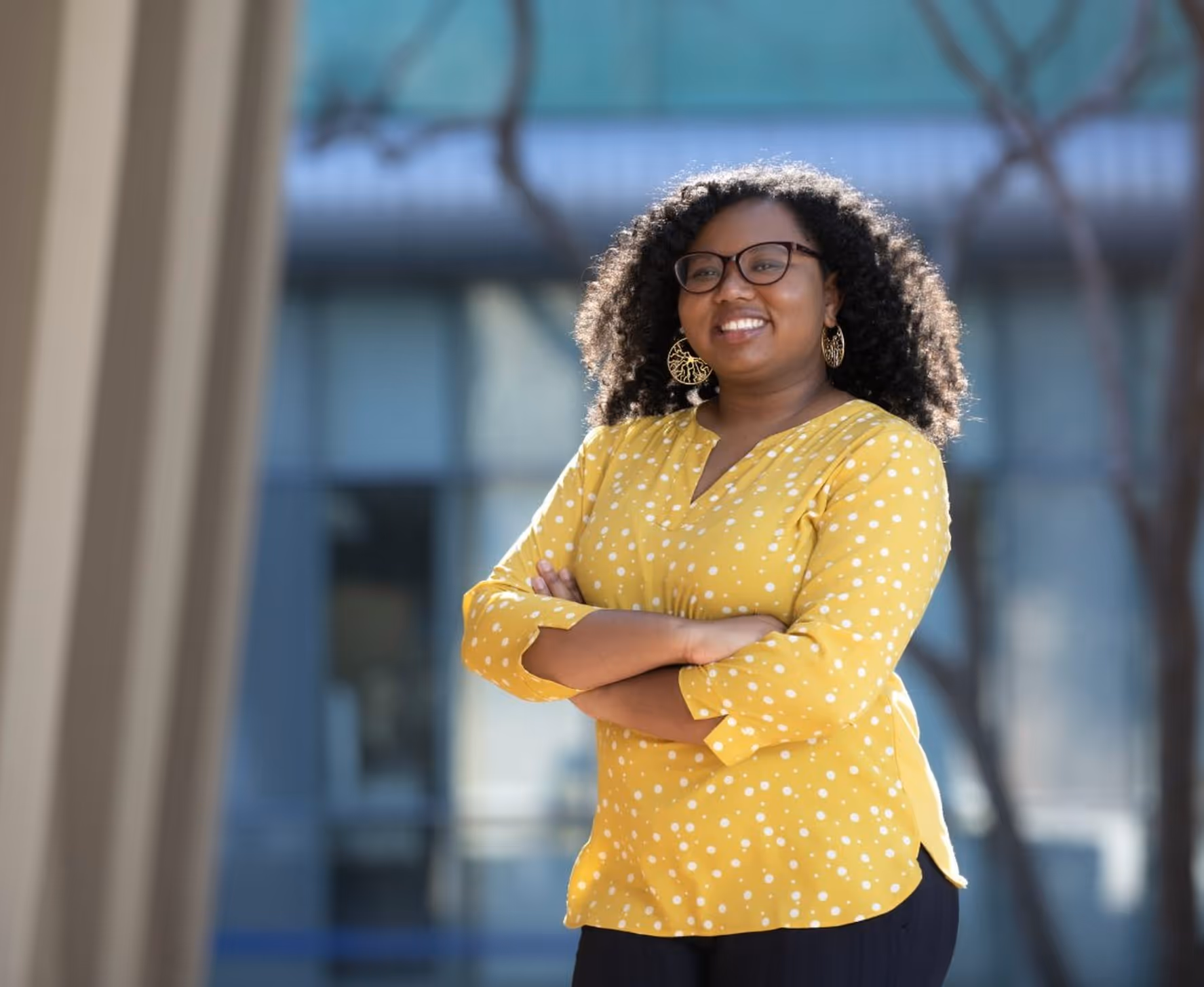 Angeline Dukes wearing a yellow shirt and smiling