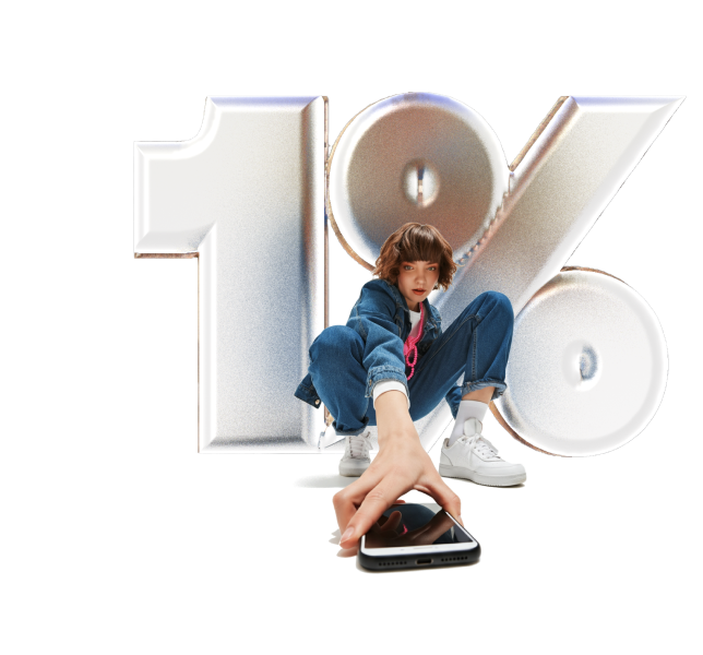 Young woman in blue denim outfit crouching and holding a smartphone towards the viewer with large silver 1% symbol behind her.