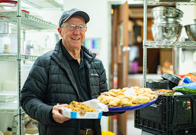 Volunteer holding a platter of food