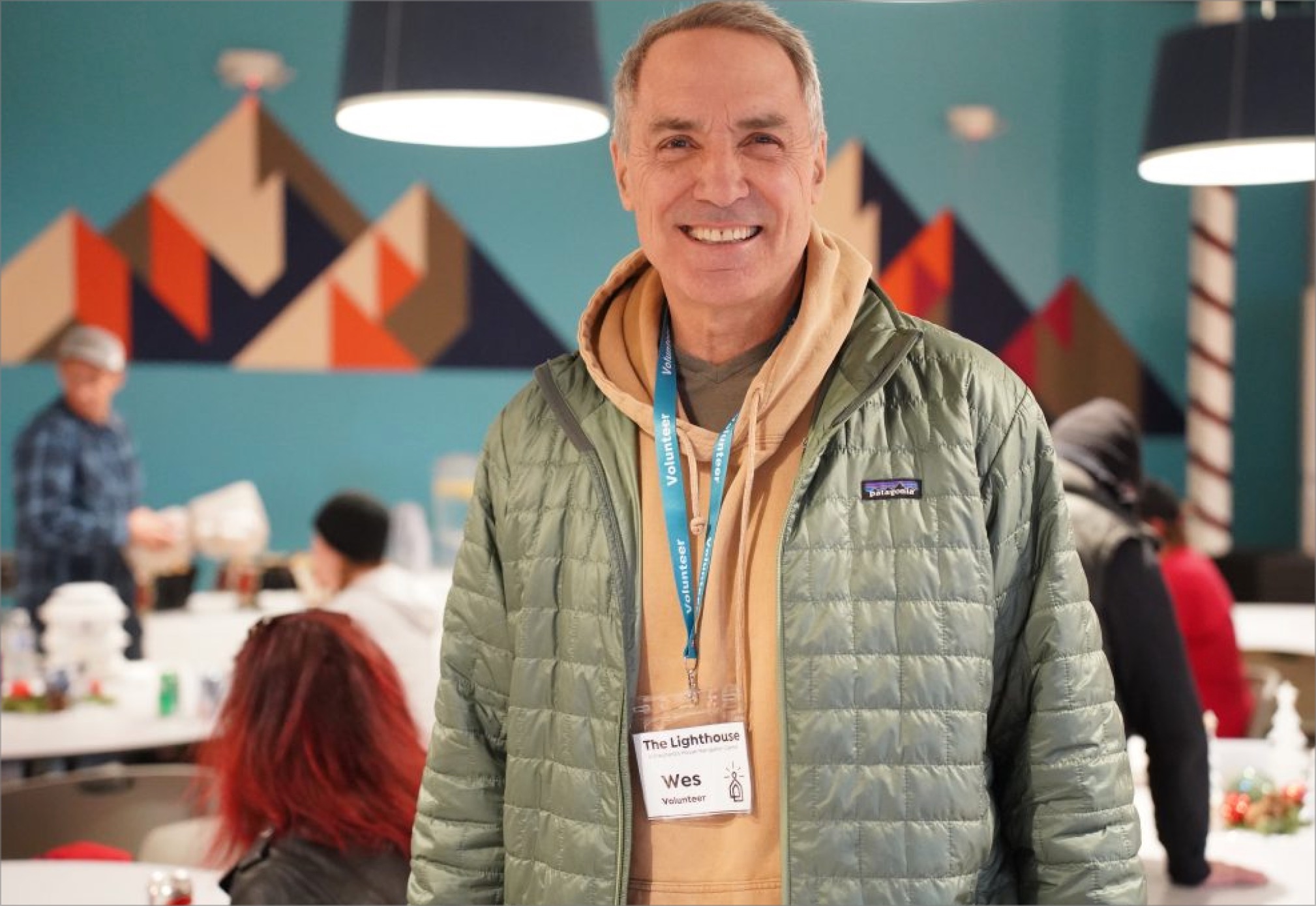 Volunteer smiling at camera