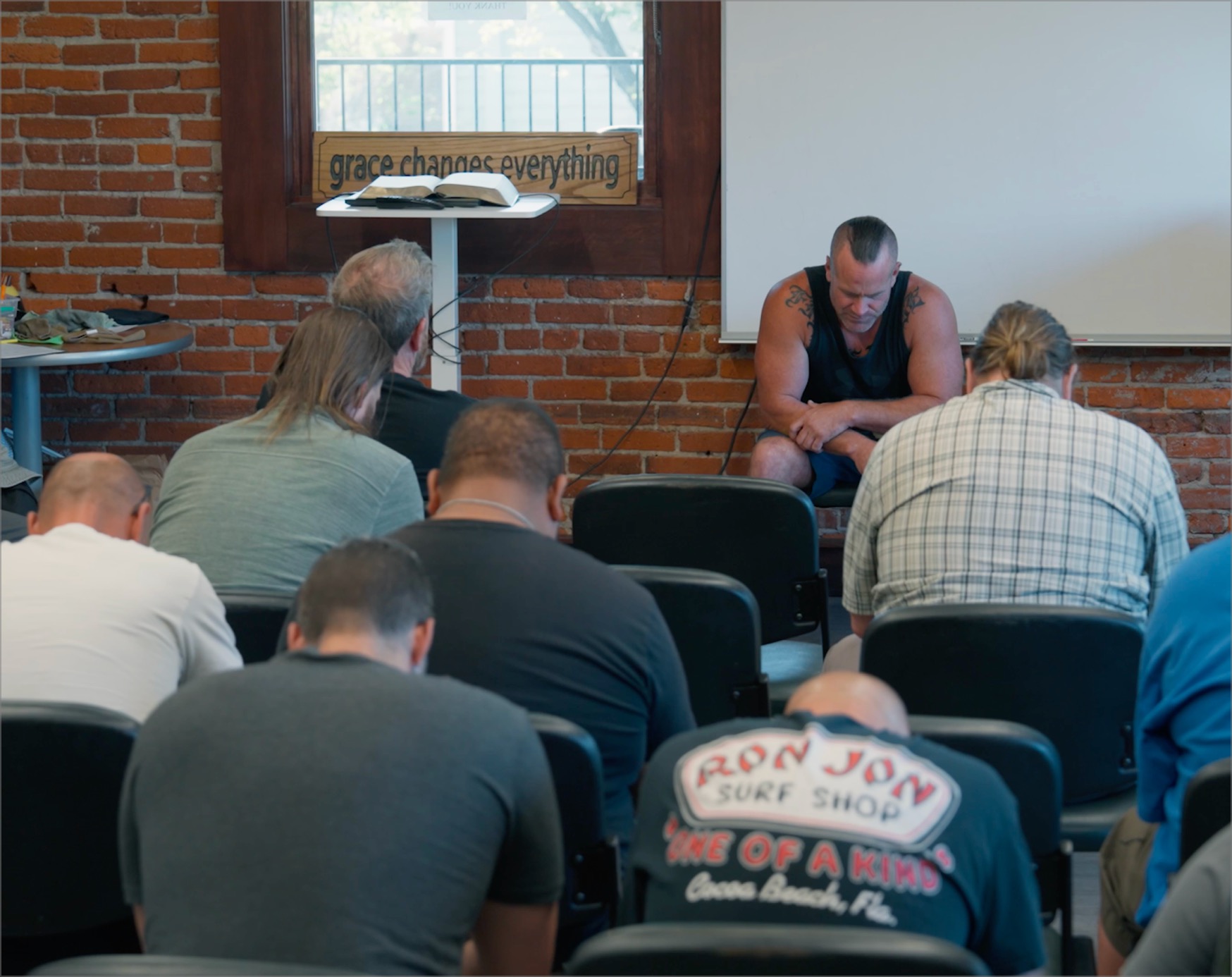 Men praying in a room
