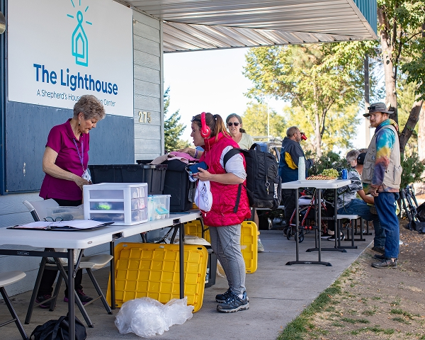 Volunteers outside of shelter, helping pass out goods