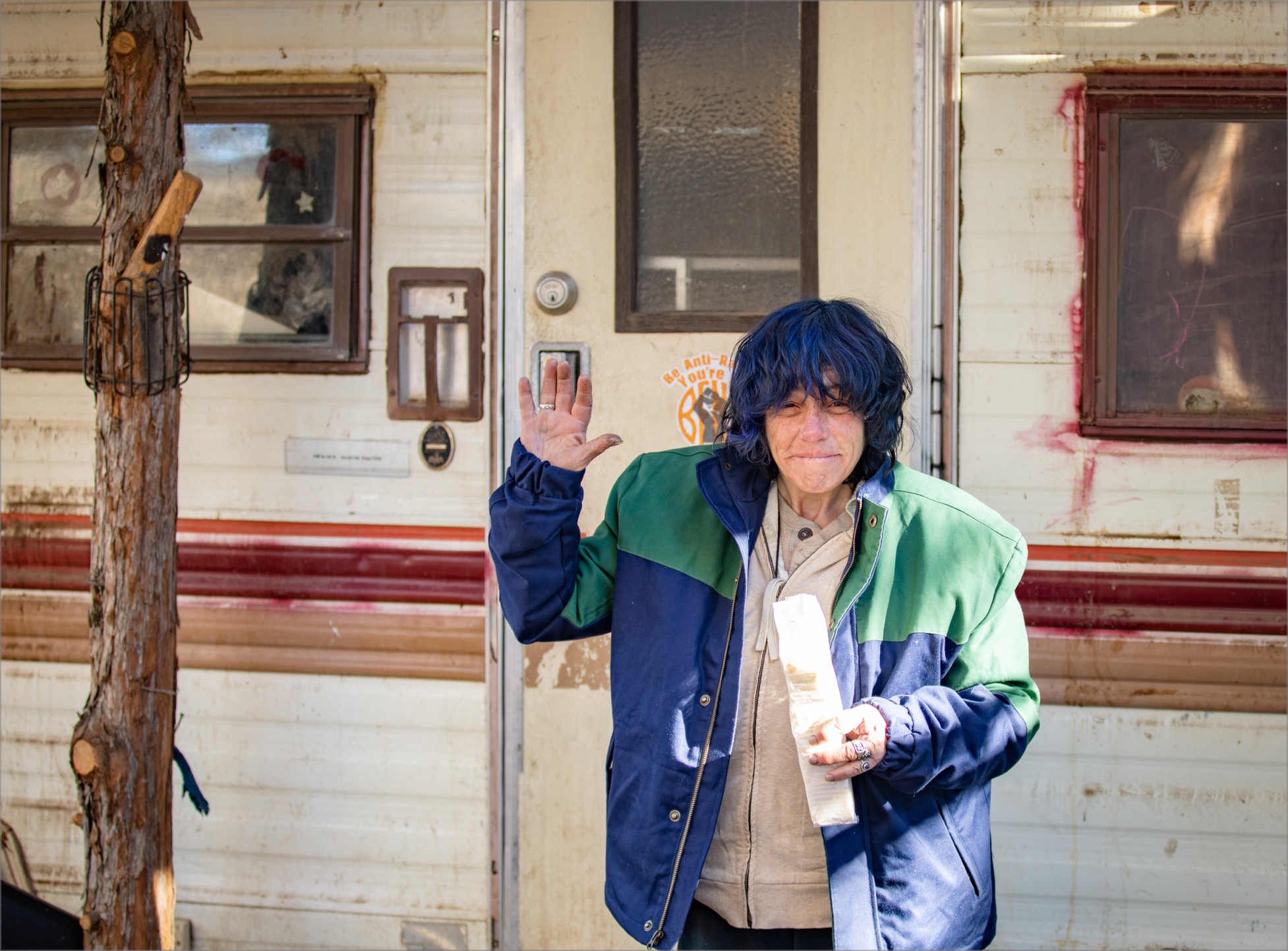 Person waving to camera outside of RV