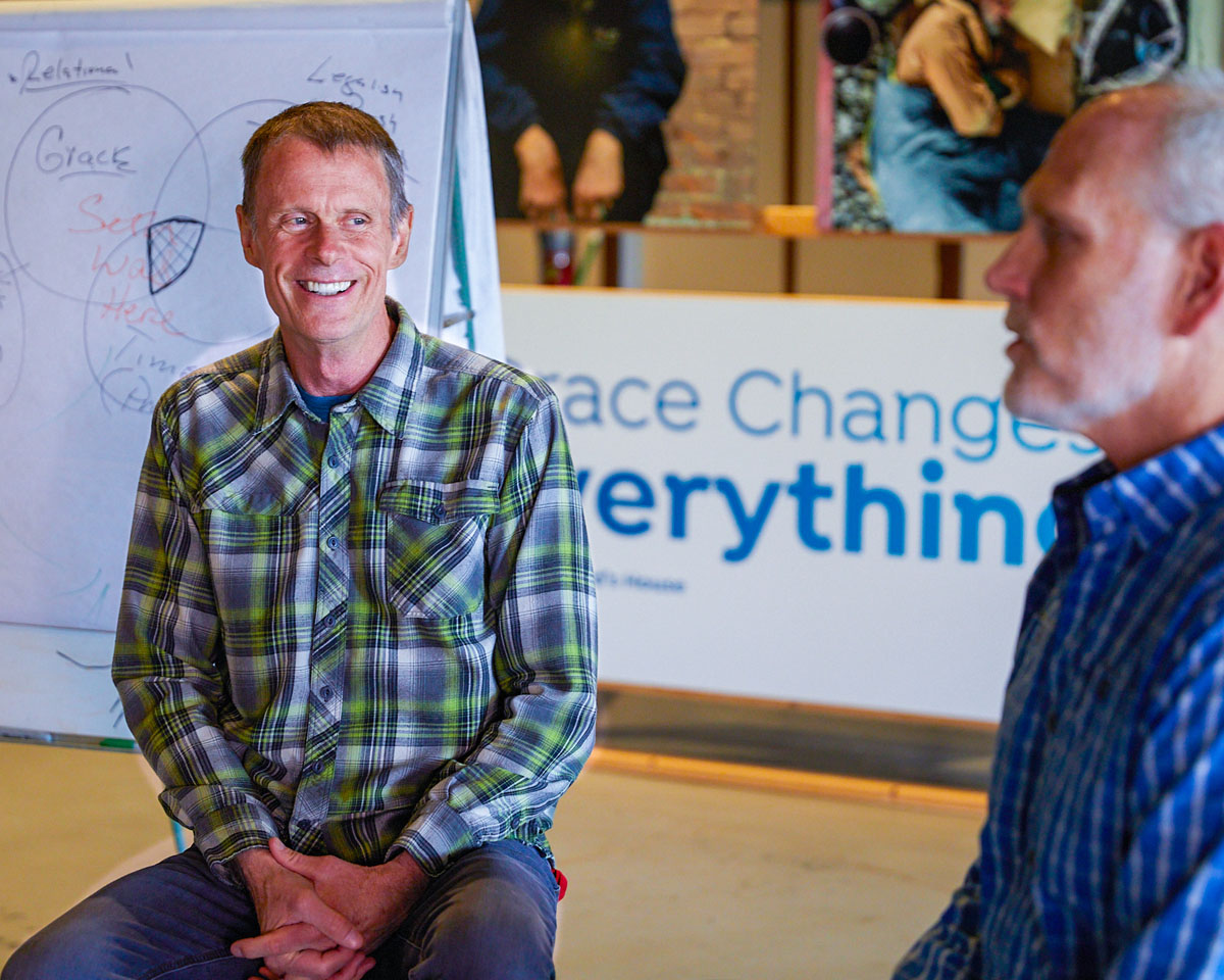 two men laughing and sharing stories