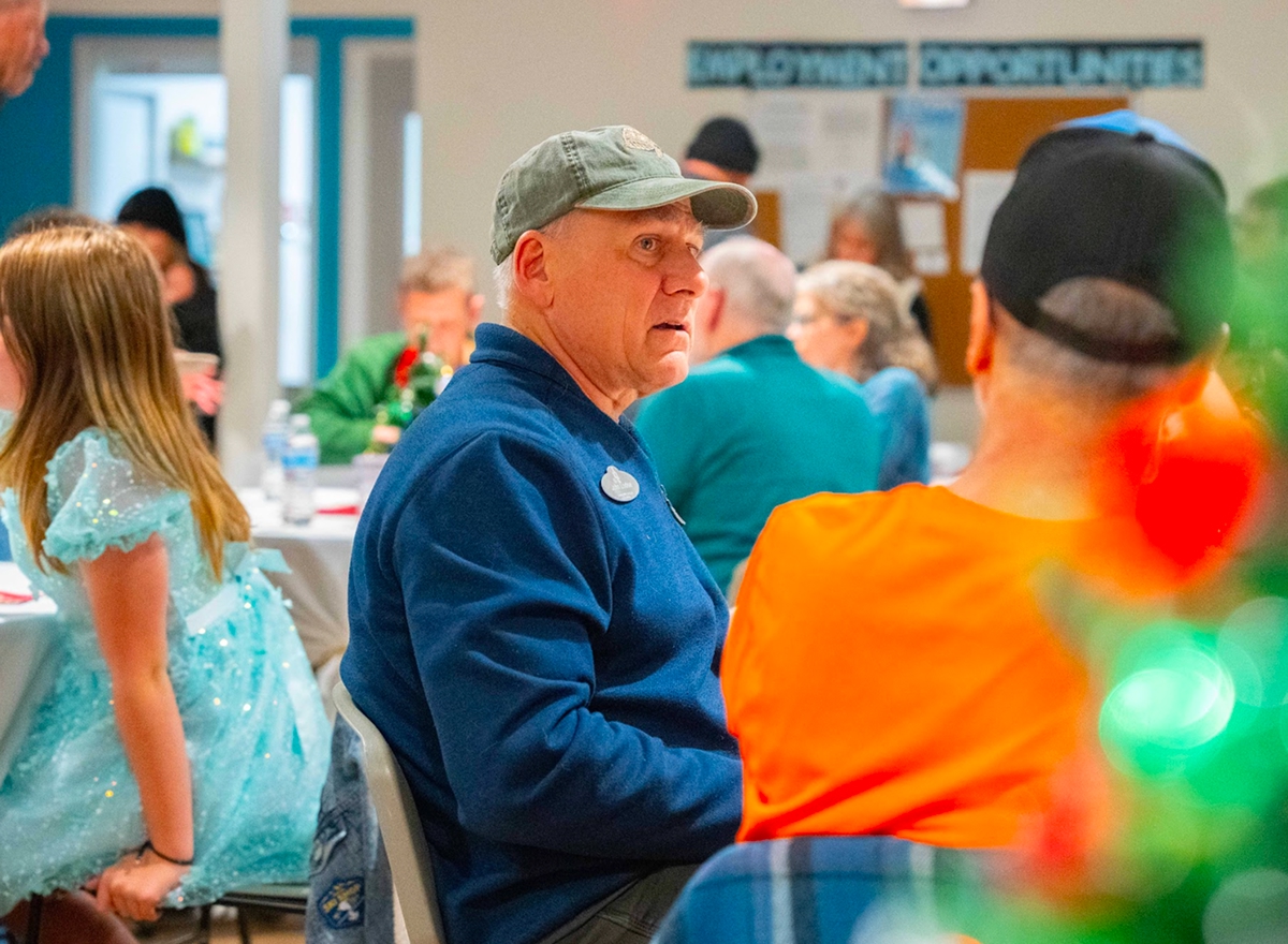 Man talking to other man at a table