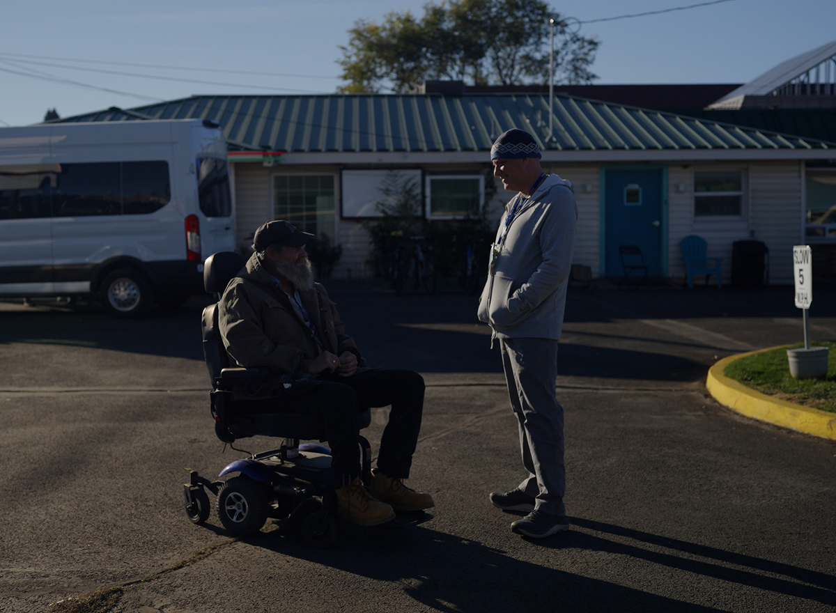 Woman with dog talking to man