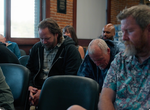 Men sitting and praying