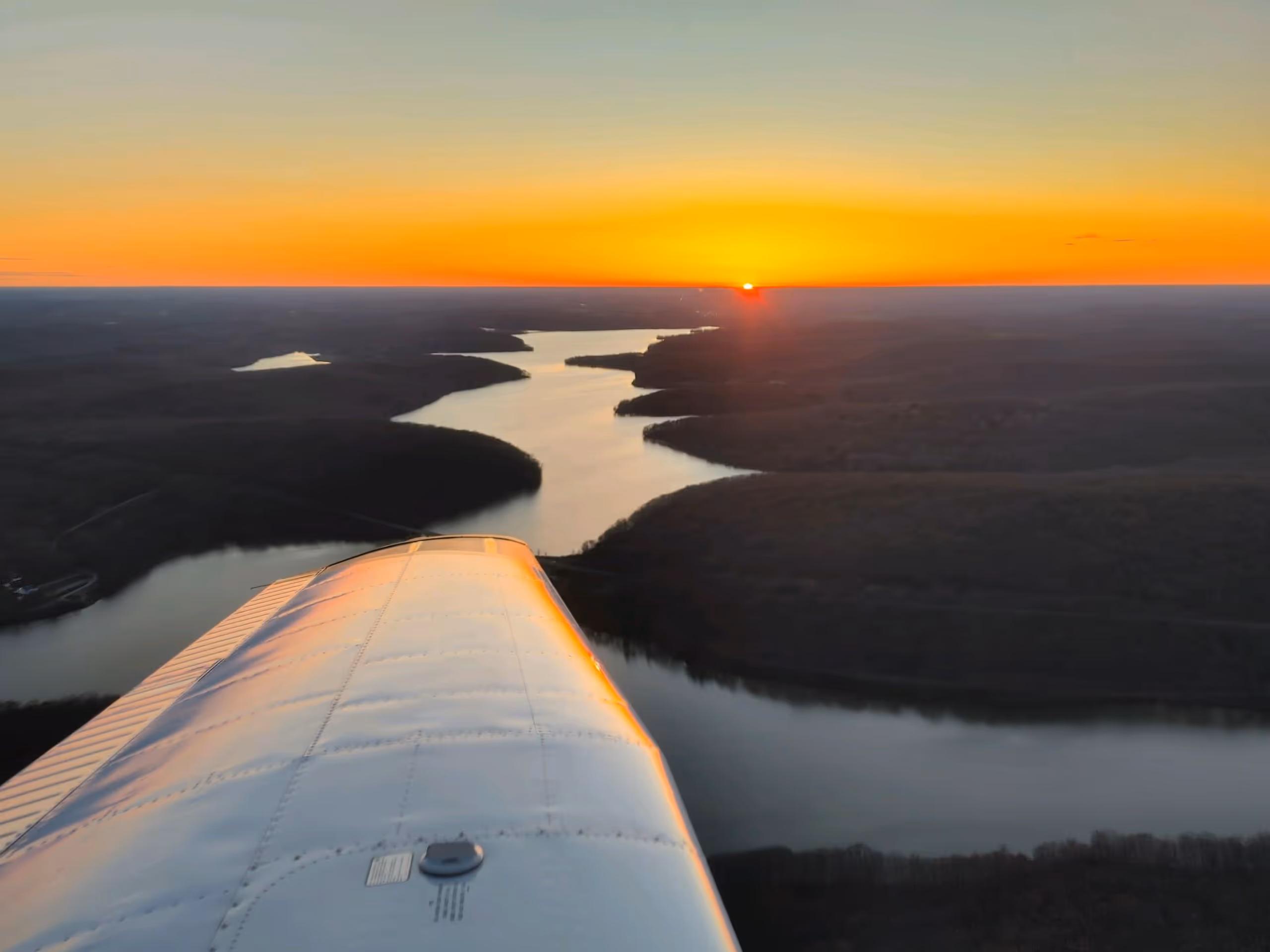 AirQuest scenic flights hero — small aircraft flying over beautiful Pennsylvania landscapes