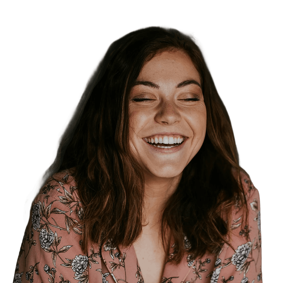 Smiling woman with closed eyes wearing a pink floral blouse.