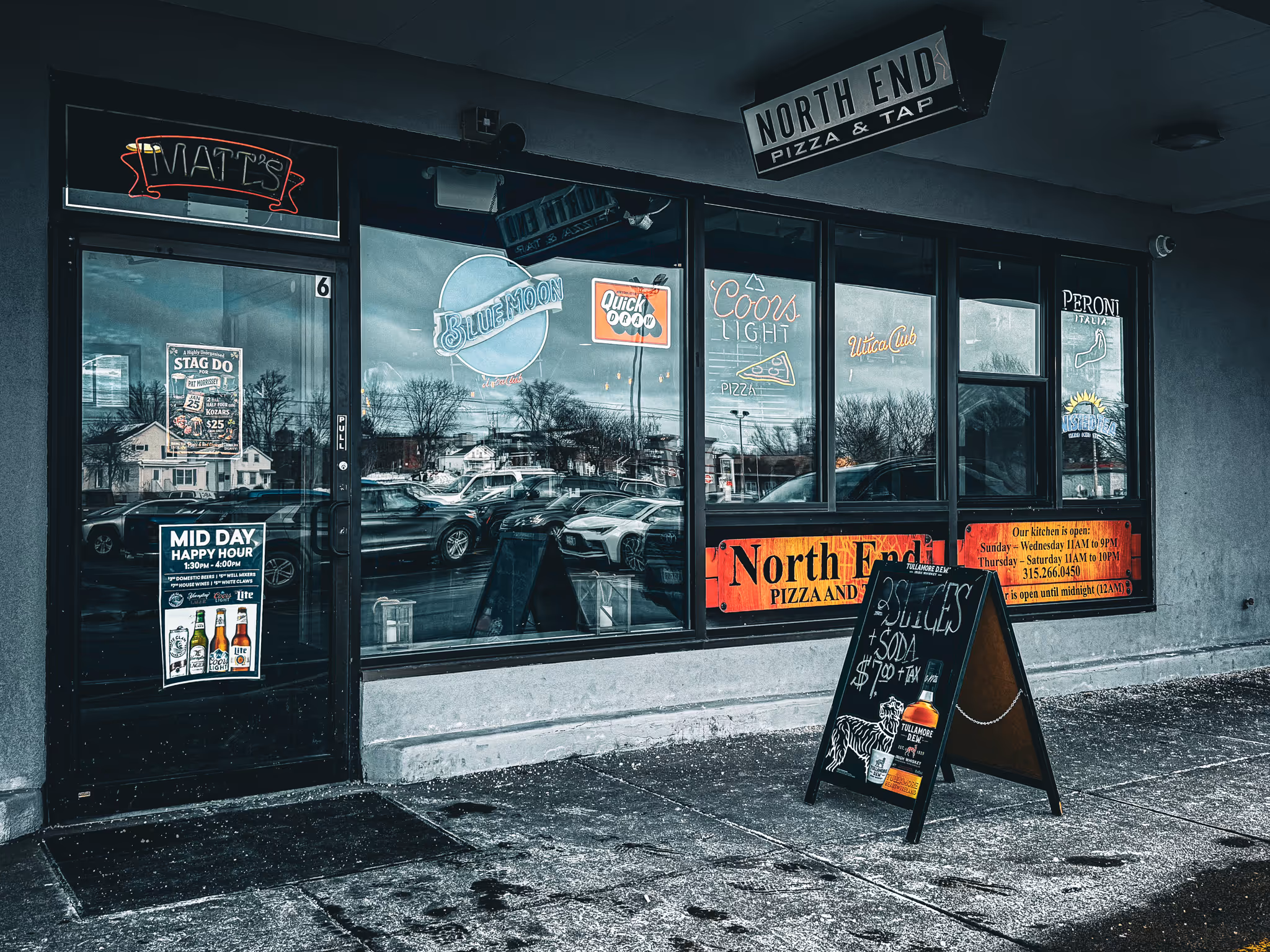 A black and white photo of a North End pizza shop.