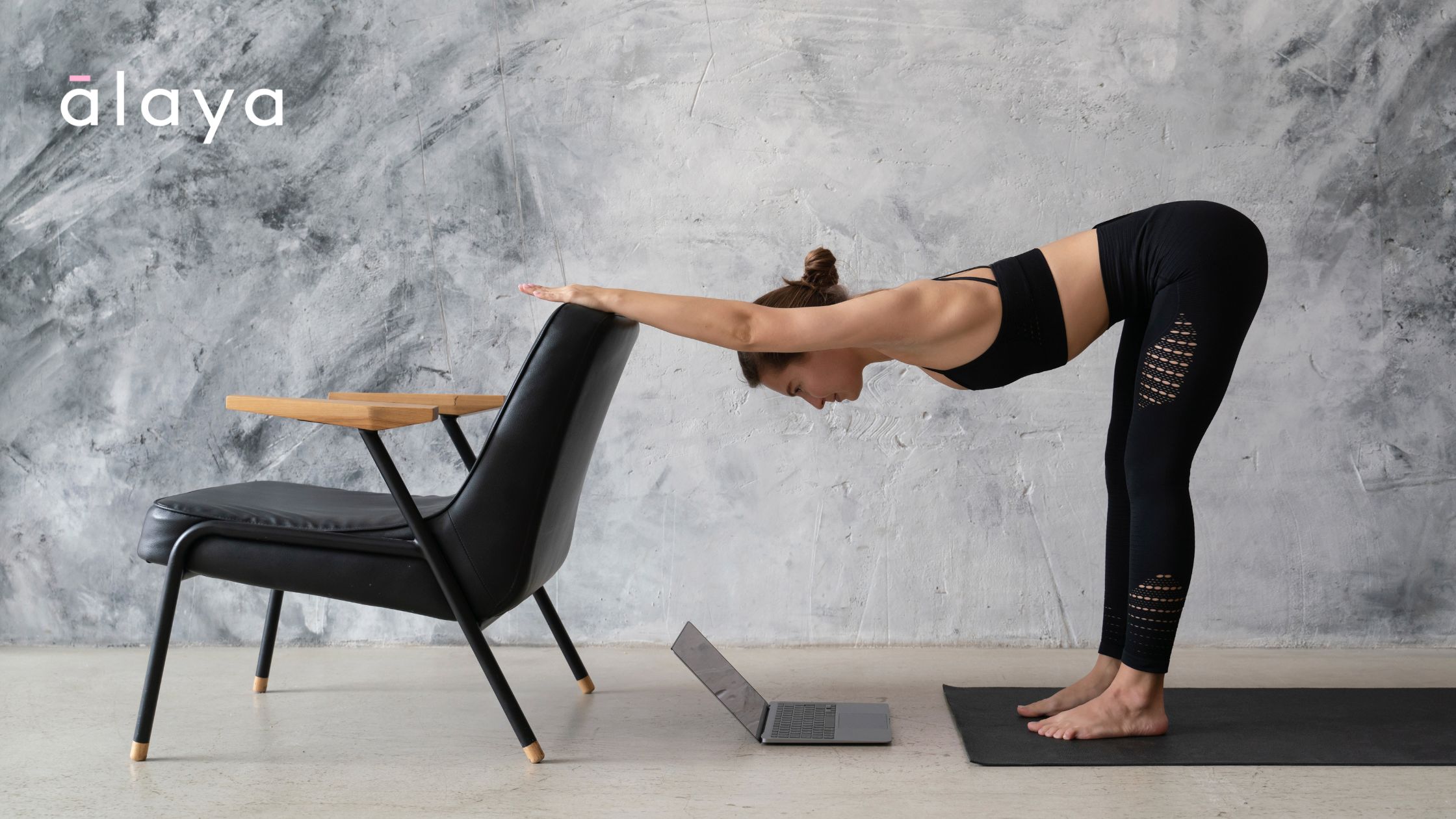 Woman doing a supported forward bend with blocks and a chair, demonstrating a therapeutic Iyengar yoga setup