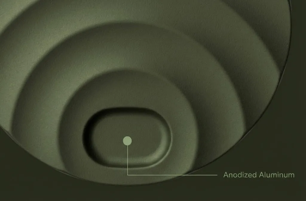 Close-up of an anodized aluminum surface with concentric rounded indentations and label.
