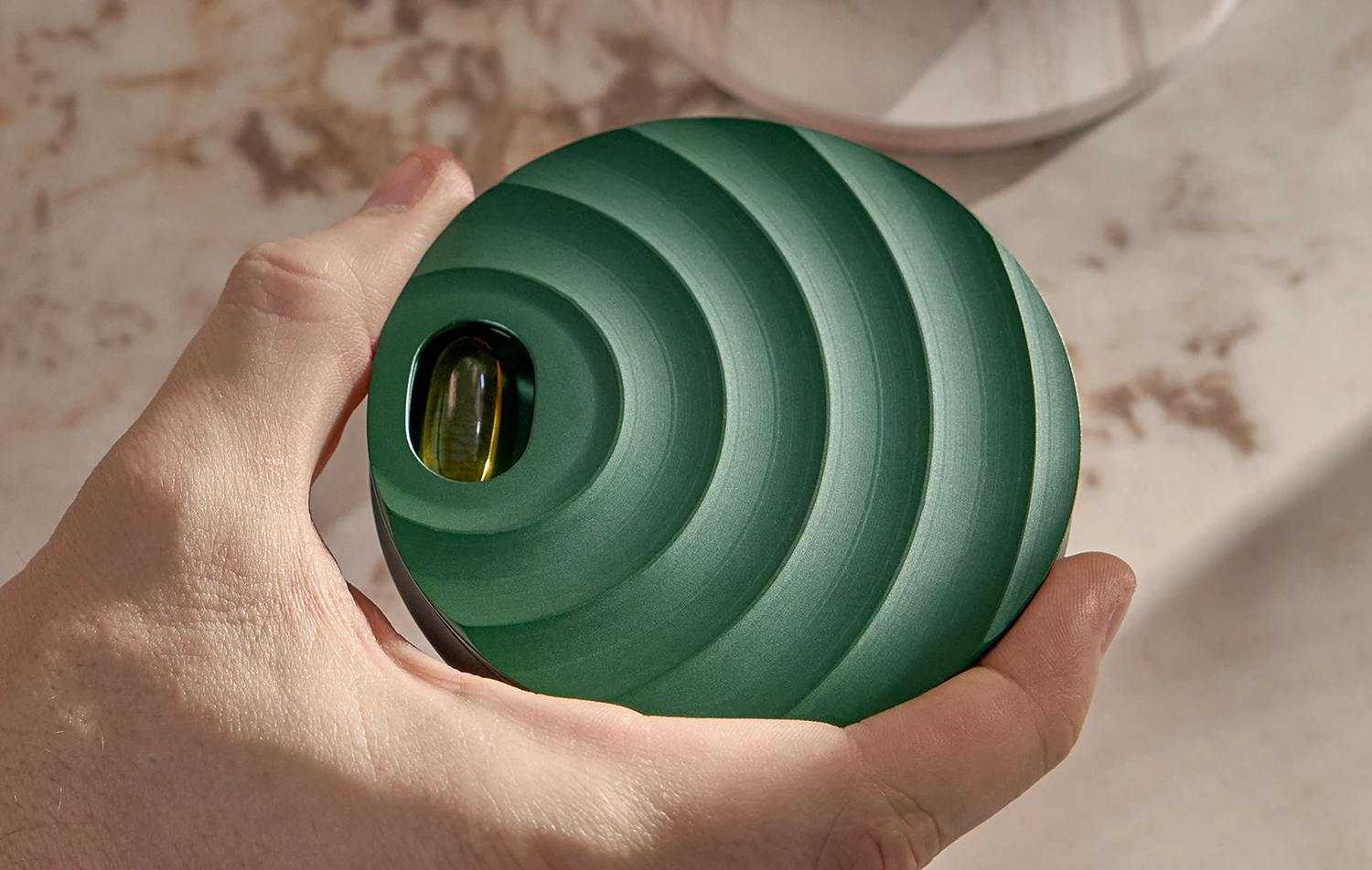 Close-up of a polished metal cylinder with circular brushed texture under studio lighting.