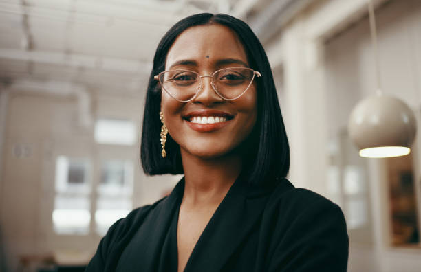 A woman with glasses smiling for the camera.