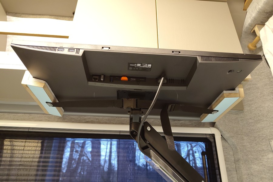 the 27" Dell display at the workspace in the back of the van in its fixated state ready for driving