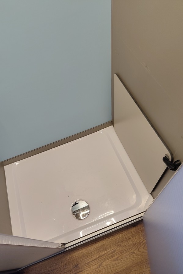a view of the shower basin inside the bathroom module