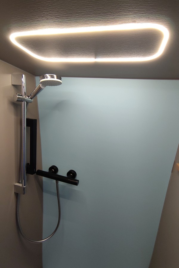 the lights and shower armature inside the bathroom module