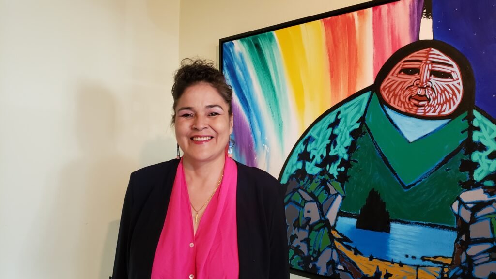 Theresa Contois standing in front of art work