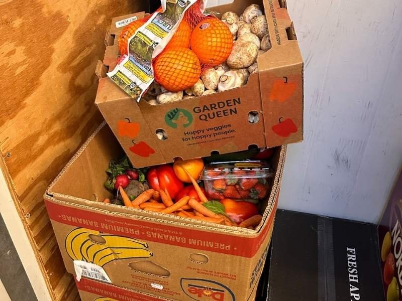 Boxes of food donations stacked.