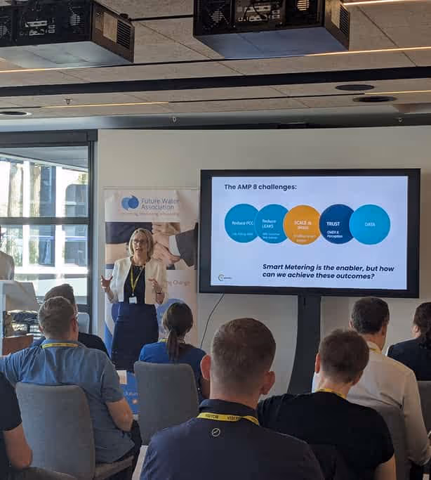 A woman presenting in front of an audience with a screen showing a slide titled 'The AMP 8 challenges' at a Future Water event