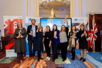 Group of eight people standing at a Future Water industry event holding awards.