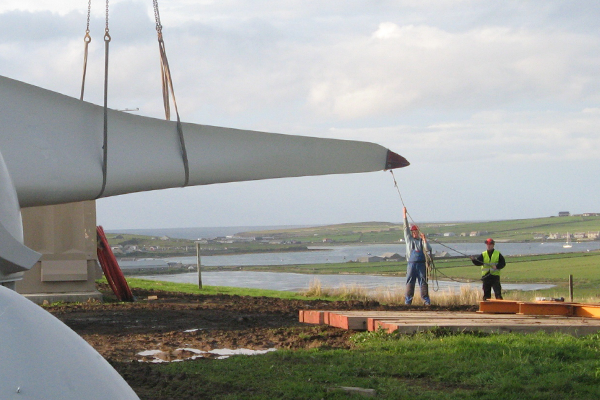 Workers assembling a community owned turbine