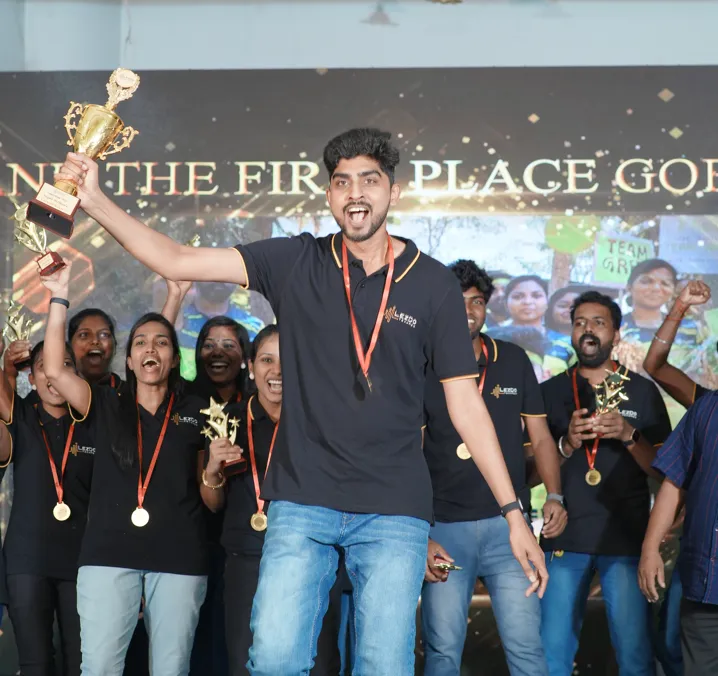 A grayscale photograph of a woman presenting ideas on a whiteboard covered with sticky notes during a meeting.