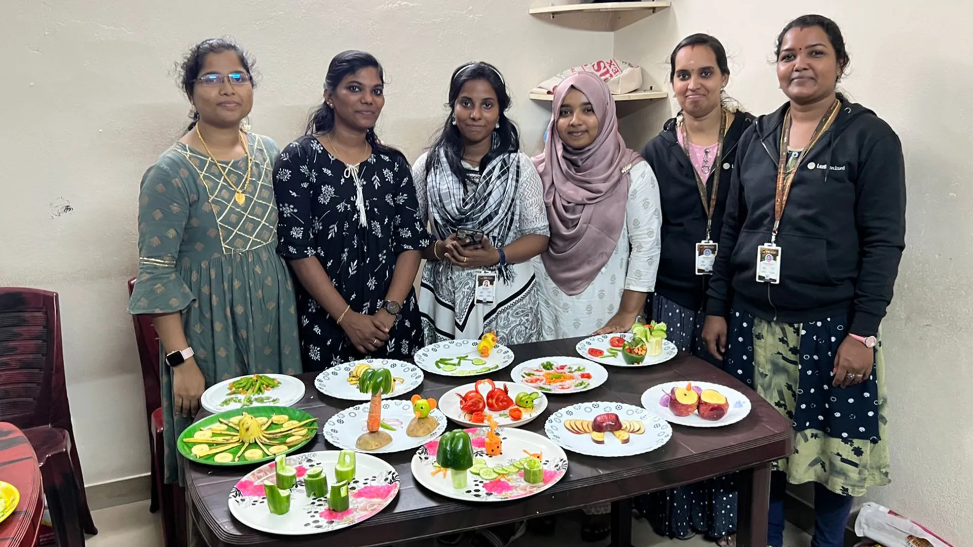 A grayscale photograph of a team attending a presentation in a conference room.