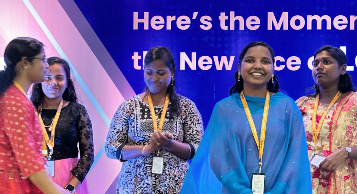 A grayscale image of a team working at a table, featuring rounded corners for a modern UI look.
