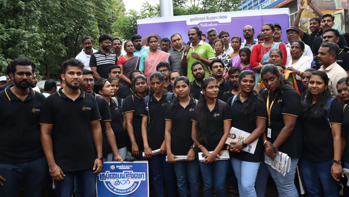 A grayscale photograph of a young student focused on writing in a notebook.