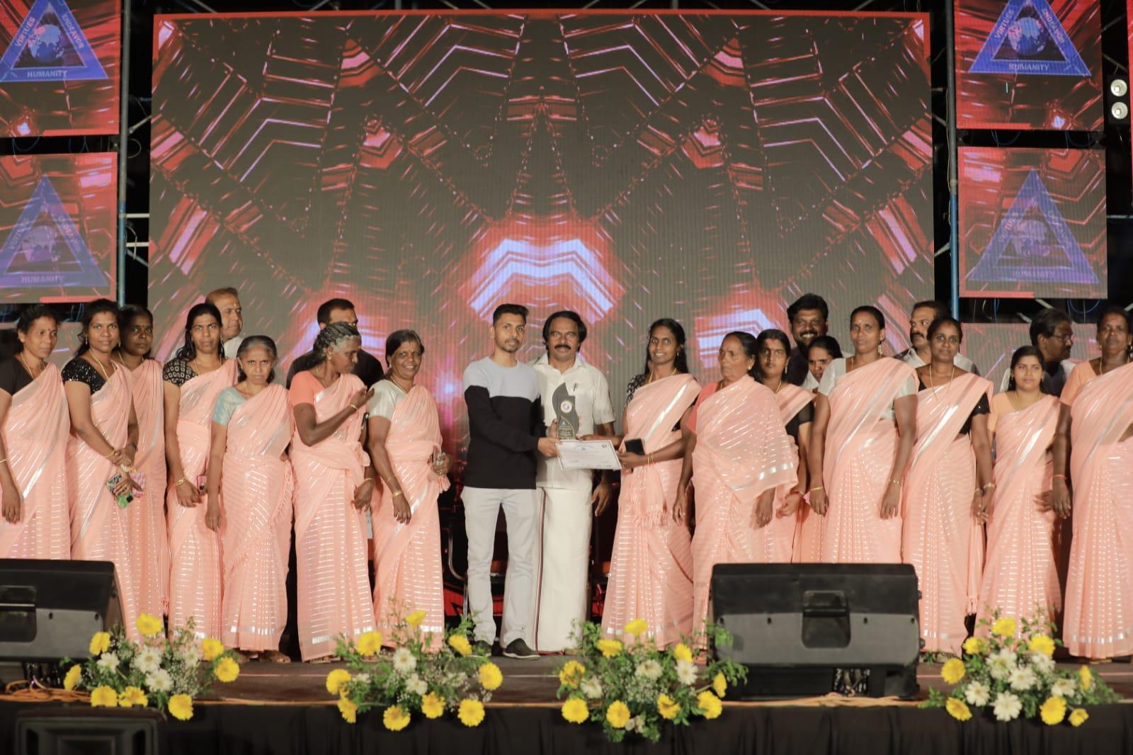 A grayscale photograph of a person wearing a 'VOLUNTEER' shirt from behind.