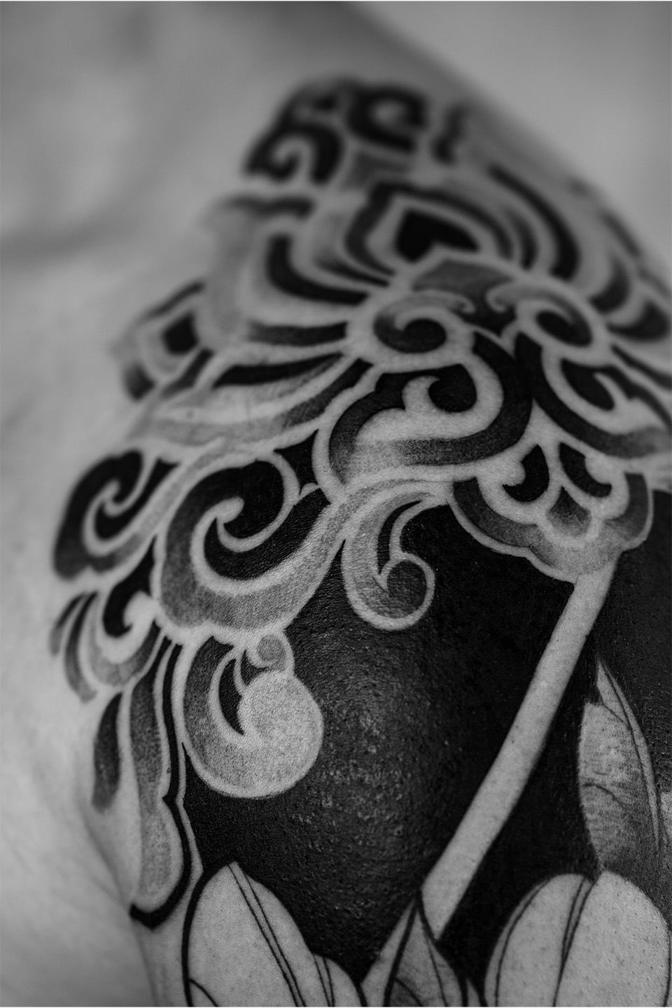 Black ink tattoo of a tiger walking forward on a person's forearm.