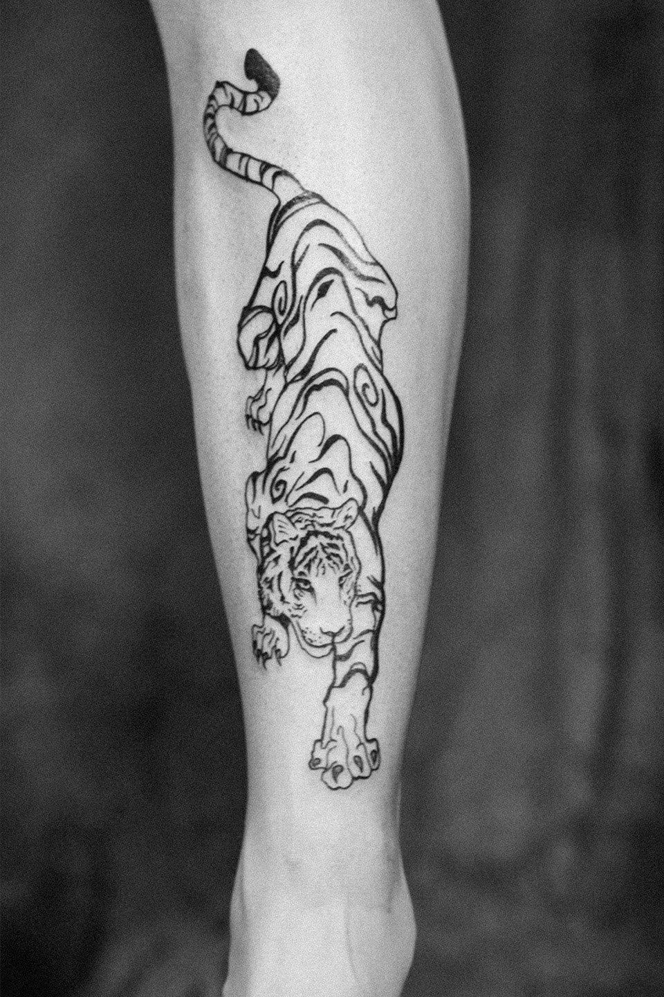 Forearm tattoo featuring interlocking geometric patterns with black outlines and shaded dot work.